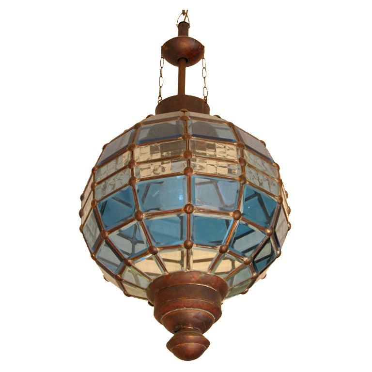 An unusual round lantern that has a brass ribbed frame fitted with four rows of beveled blue glass panes divided by four ribbed clear glass sections. Vienna (?), ca. 1900.