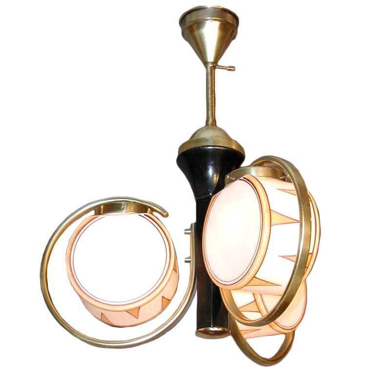 An unusual Art Deco period three light chandelier having a wood shaft supporting 3 brass arms fitted with white glass globes decorated with snare drum motifs. Berlin, circa 1930.