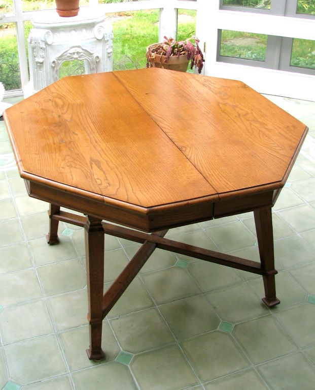 A beautifully figured octagonal oak center table, which was at one time extendable with leaves and could be made to do so again. Belgian, Ca. 1900.