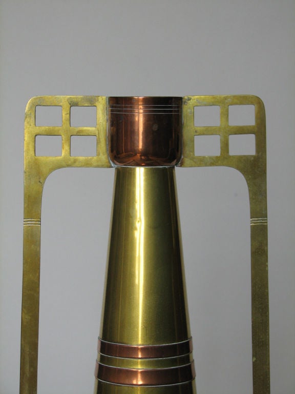 A striking Secessionist period vase executed in brass and copper in a geometric design. Made by the C. Kurz Company, Tiel, Holland. Marked. The design in the manner of Gustave Serrurier Bovy, circa 1905.