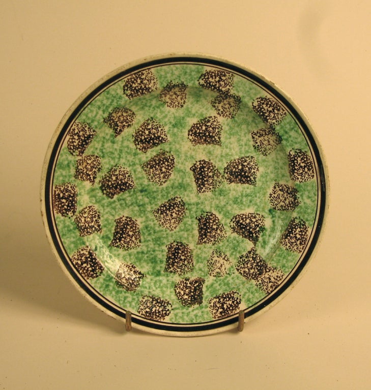 A circular green and black sponge decorated Forge-les-eaux bone china plate, France, circa 1855.