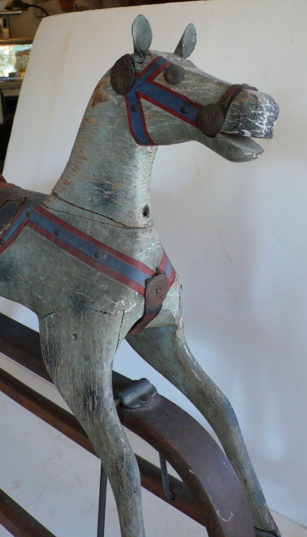 A beautiful early hobby horse on original stand that moves, Leather Saddle, real horsehair tail, great old paint