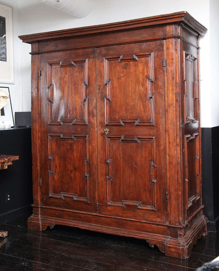 A large scale 18th C. Italian Walnut Armoire with very clean modernist details including raised panels on the front doors and sides. The interior includes a center shelf and potential hanging capabilities.
Can be dismantled for shipping and