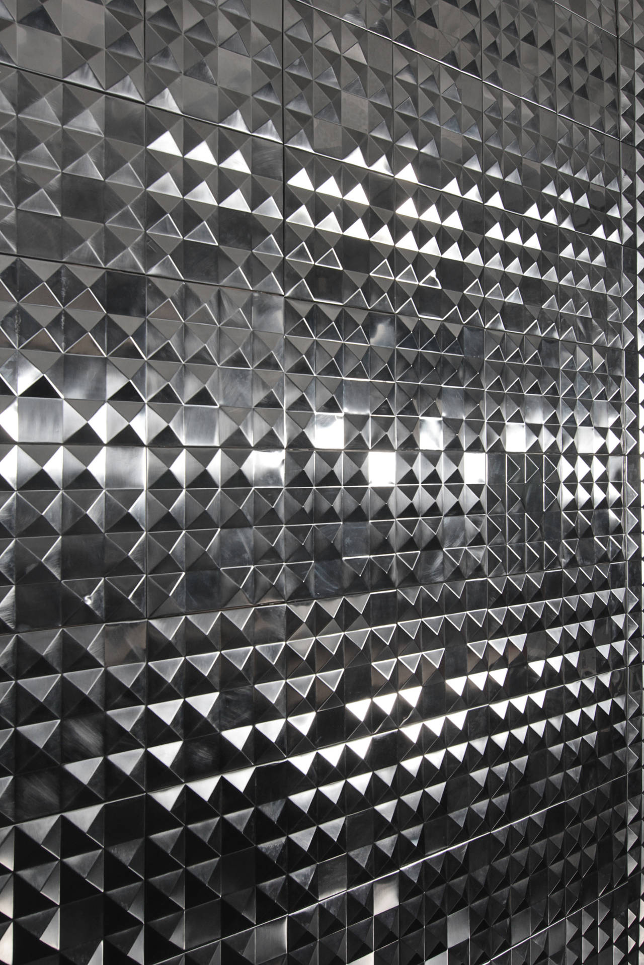 A super sexy luminous steel wall panel. The random shapes reflect light softly to create a statement in any room.
Backed on wood and hung on three panels.