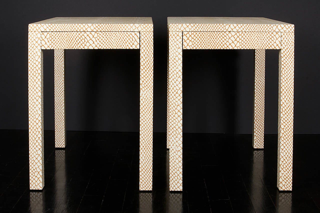 A pair of snakeskin embossed leather side tables with small drawer.