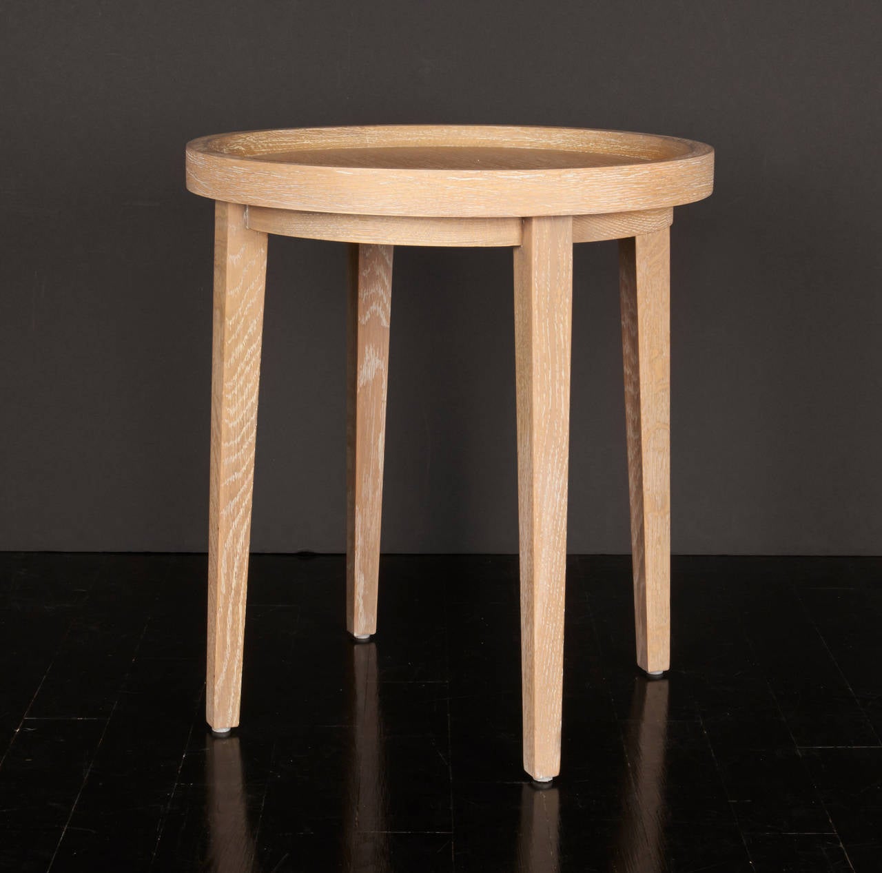 A small French oak side table with tapered legs and a round tray top.
