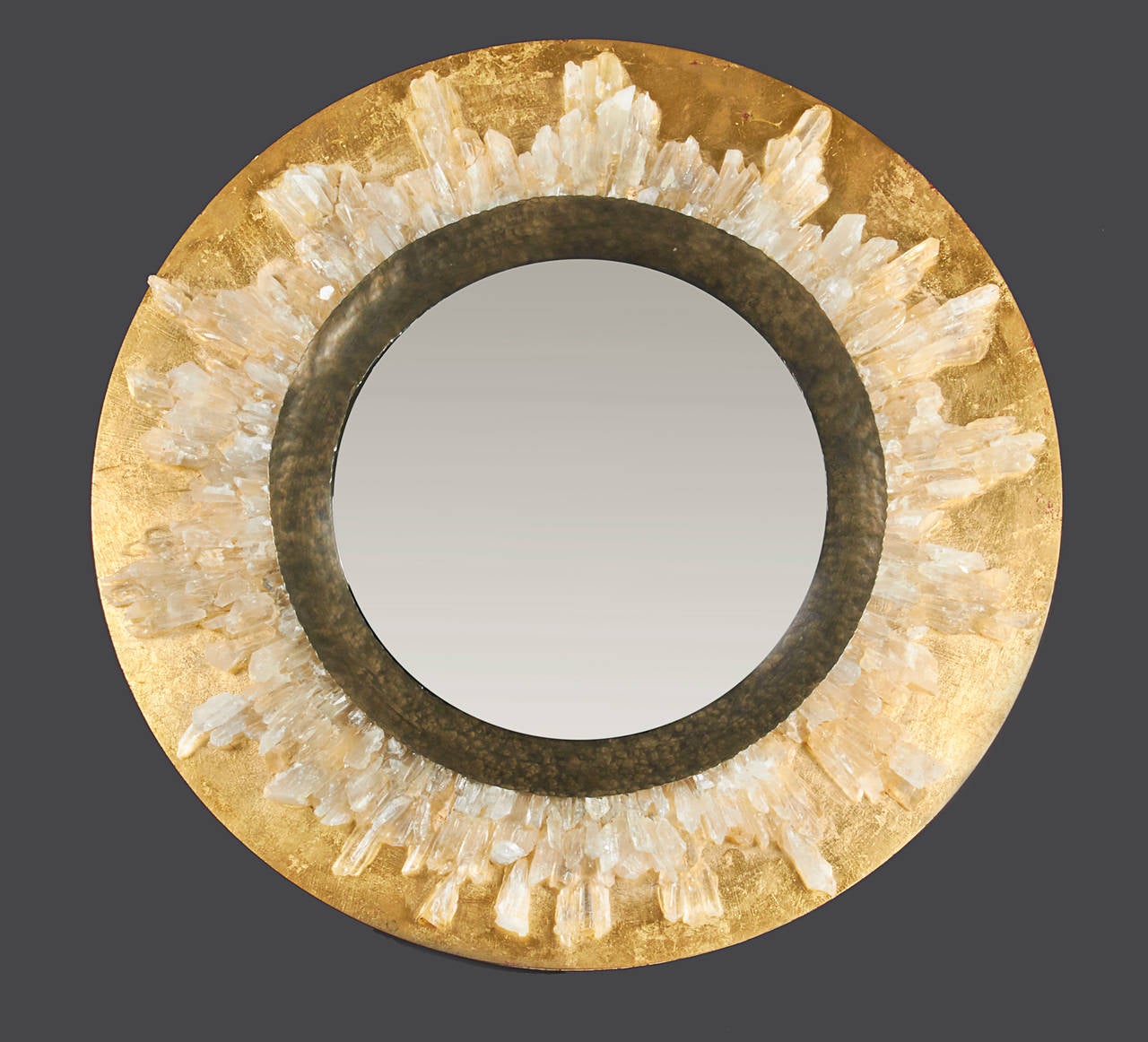 In the style of Goossens Paris, this mirror is embellished with Crystals arranged around a Bronze band with a Giltwood base. Wall jewelry to enhance any space.