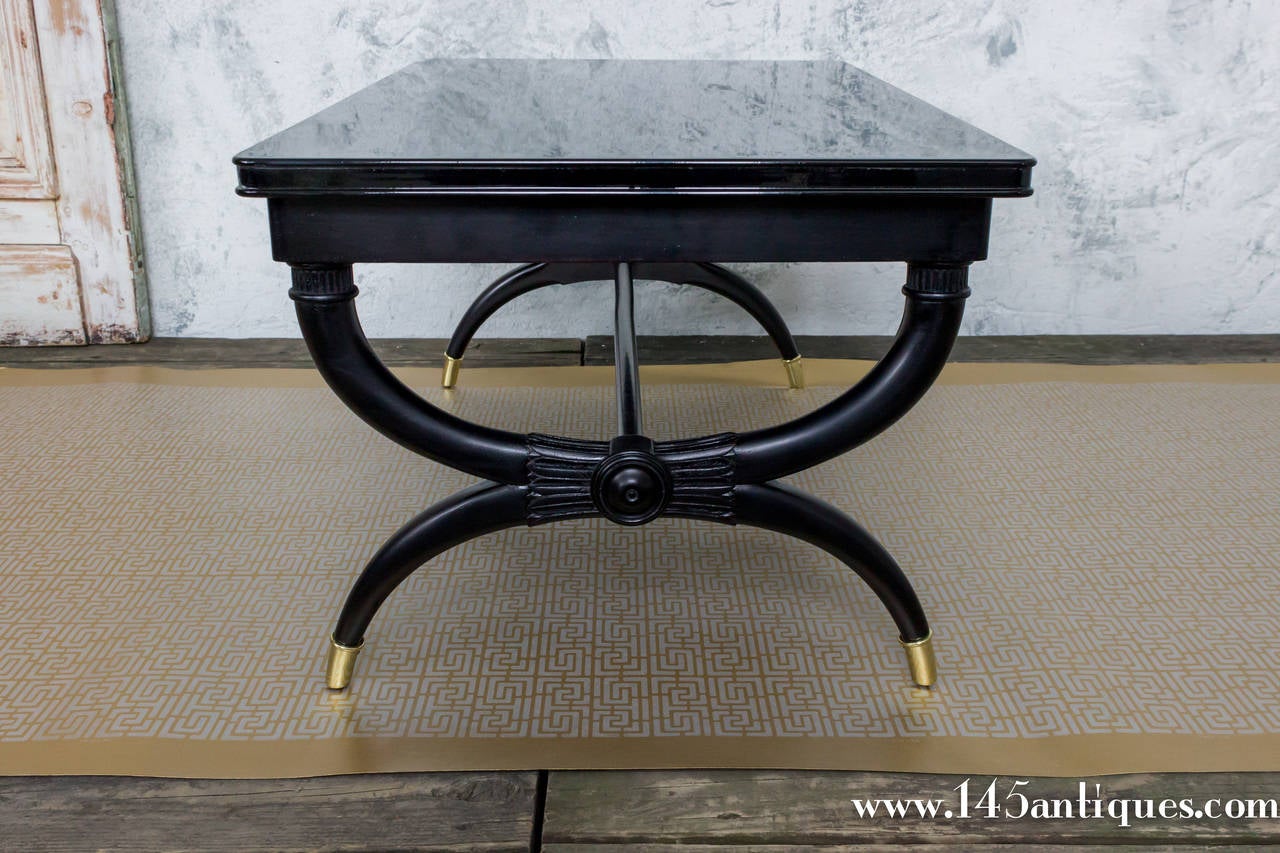 French Directoire styled ebonized coffee table with brass sabots.