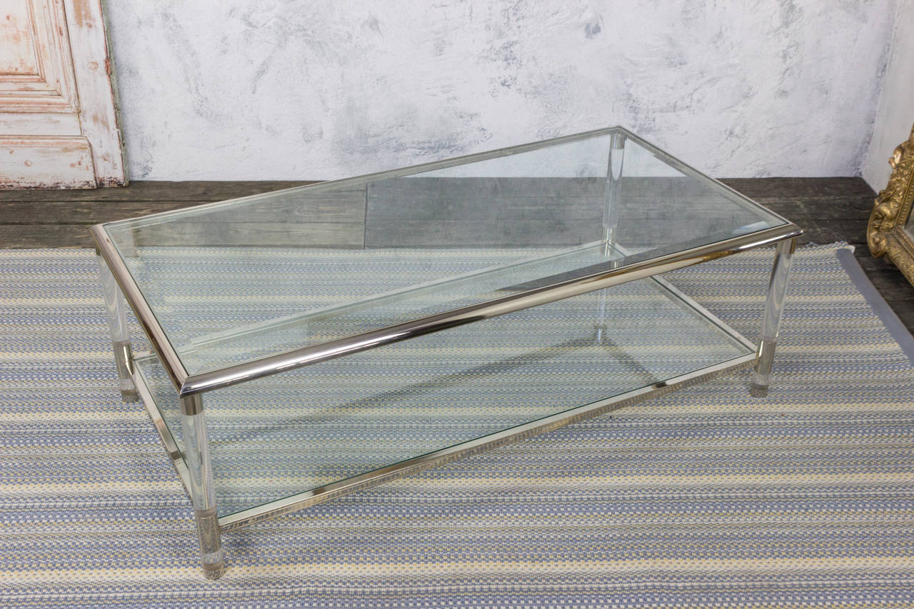 French coffee table with Lucite and chrome frame and beveled glass shelves. Two are available to make a pair.