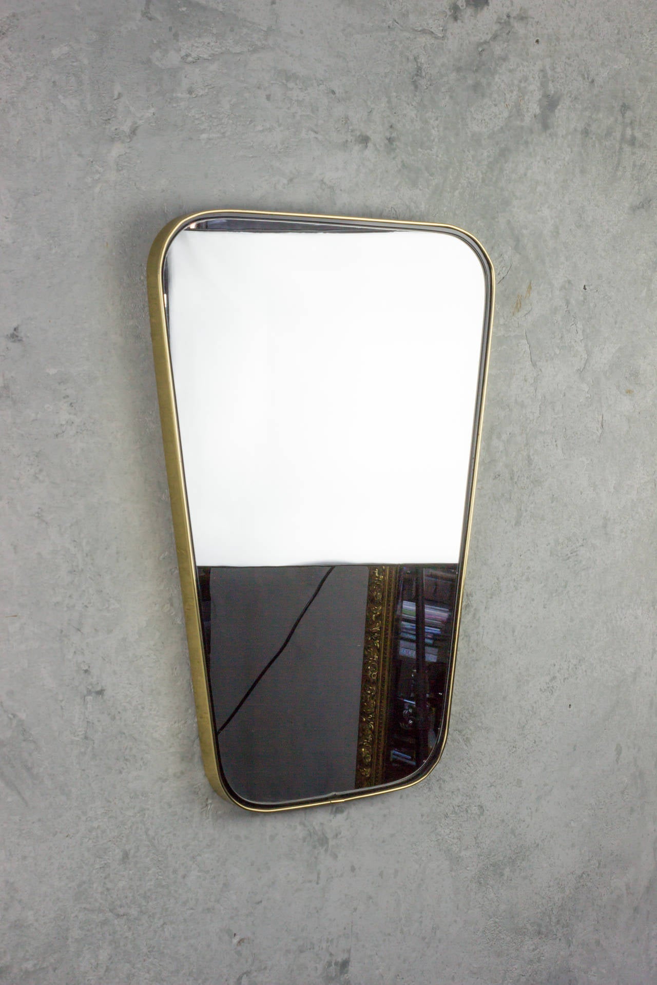 This is an Italian mirror in a brass trapezoid with rounded edges. Original glass , Circa 1960.