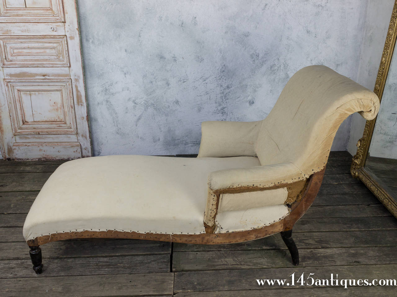 French Napoleon III chaise lounge in muslin featuring gentle curves with a scrolled back. Sold as is. Upholstery services available upon request.