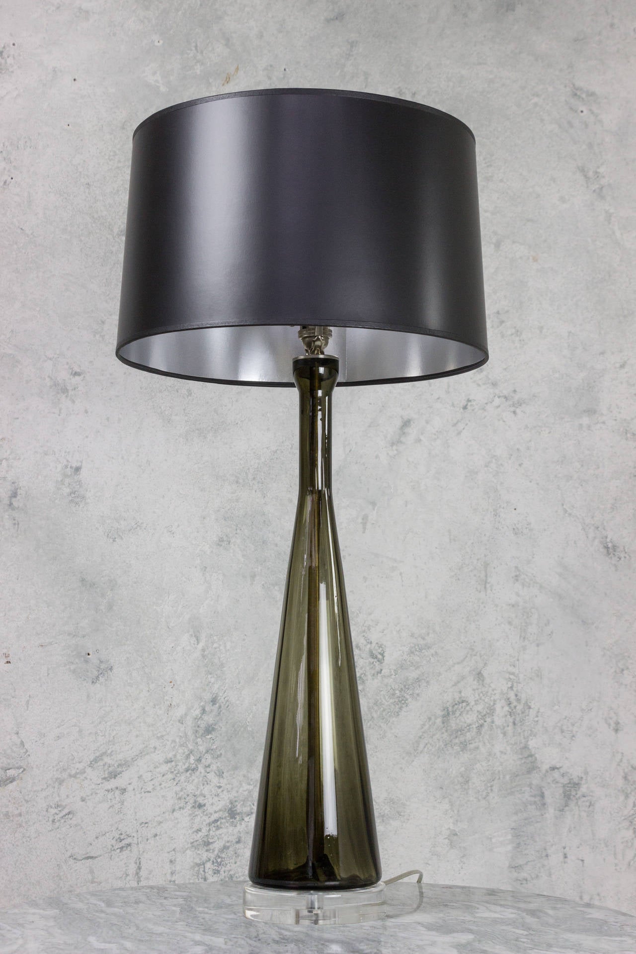 Tall black glass table lamp with plexiglass base. This lamp has been newly wired with three-way socket.