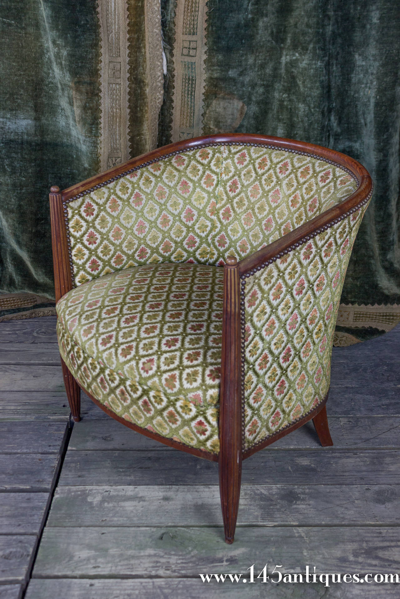 Pair of French Art Deco armchairs with curved back, fluted legs and a ball final detail. These chairs are part of a set that includes two side chairs (ST0215-07) and settee (ST0215-05), all of the set is sold separately. This pair is in good