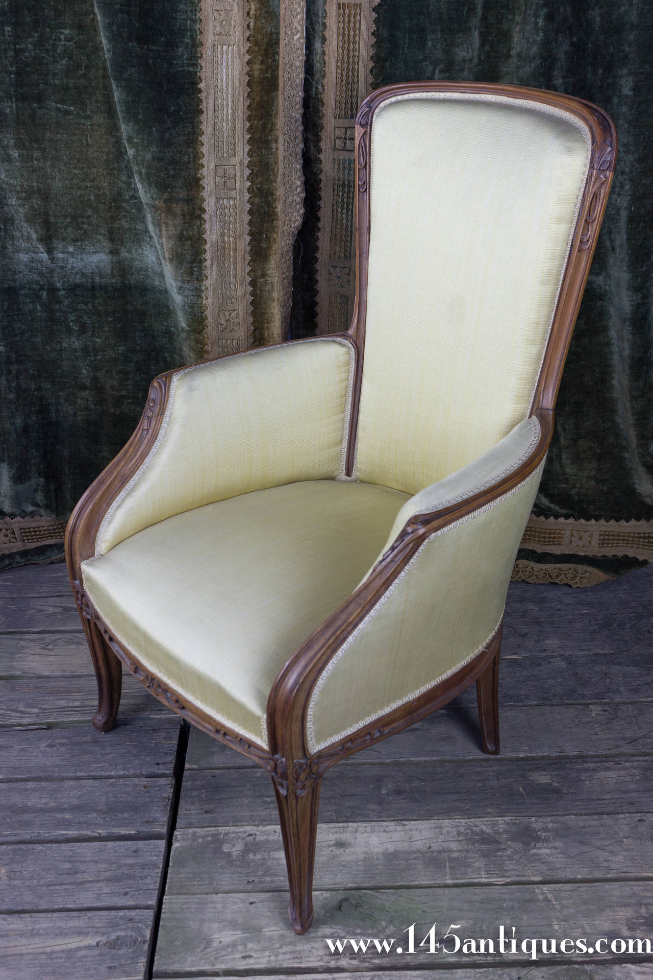 Art Nouveau chair upholstered in cream/yellow tone fabric with hand-carved wood trim. There are two matching side chairs available (ST0215-08B). The armchair is sold separately.