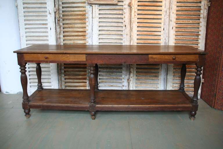 Beautifully constructed draper's table with carved legs and 2 drawers. Original  patina over oak.