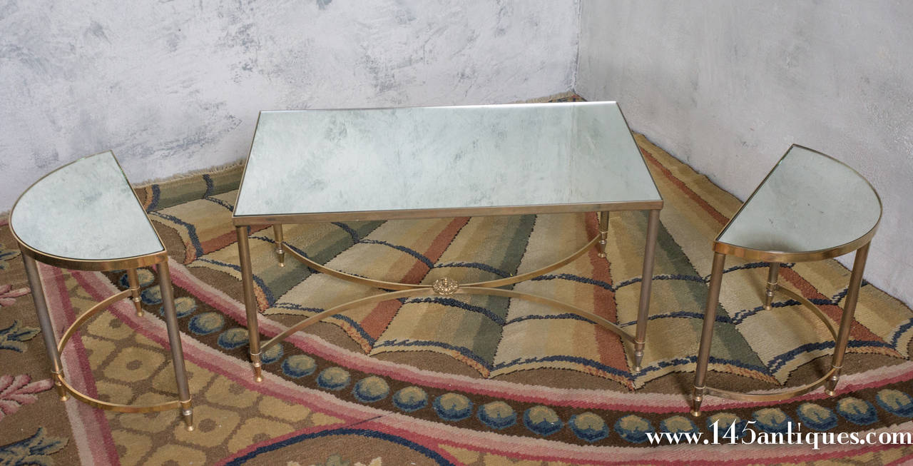 Excellent condition, late 1940's French brass three piece sectional coffee table featuring mirror surfaces. The three sections can be combined in any fashion; as a single coffee table, a rectangular coffee table with two demi-lune side tables or