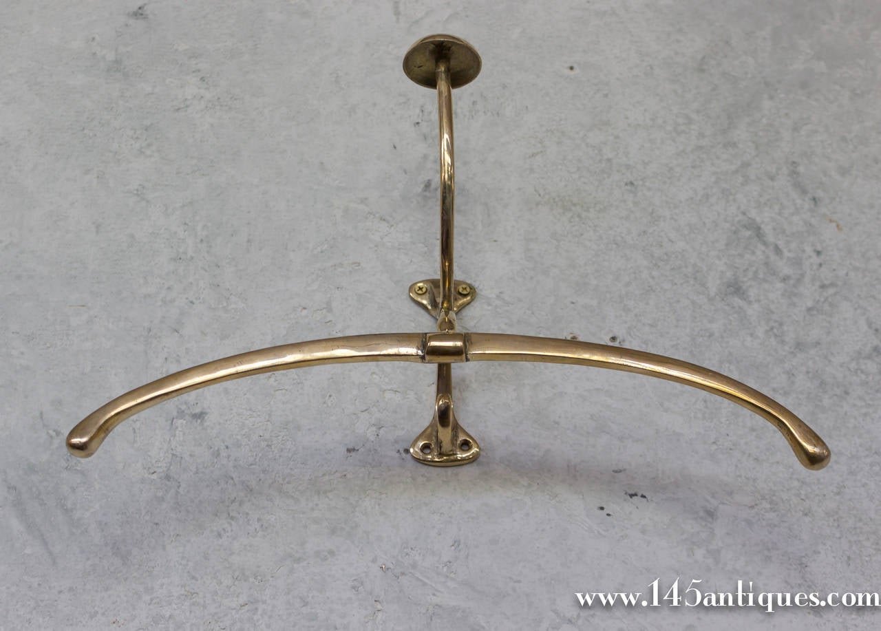 Unusual set of brass hooks, made to accommodate  both a coat and  a hat. Made in cast brass with a beautiful aged patina. French 1920's 

Only a pair left in stock.