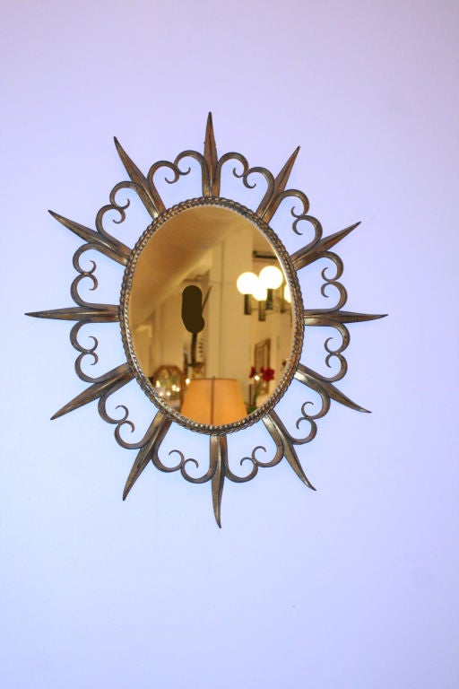 An Elegant Oval Spanish 1950's Gilt Metal Sunburst Mirror with  Decorative Scroll Work
