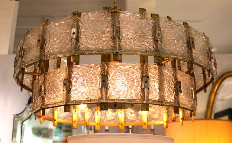 Mid Century Modern French 1960's brass chandeliers with glass pieces on two tiers.  There is a matching chandelier available.