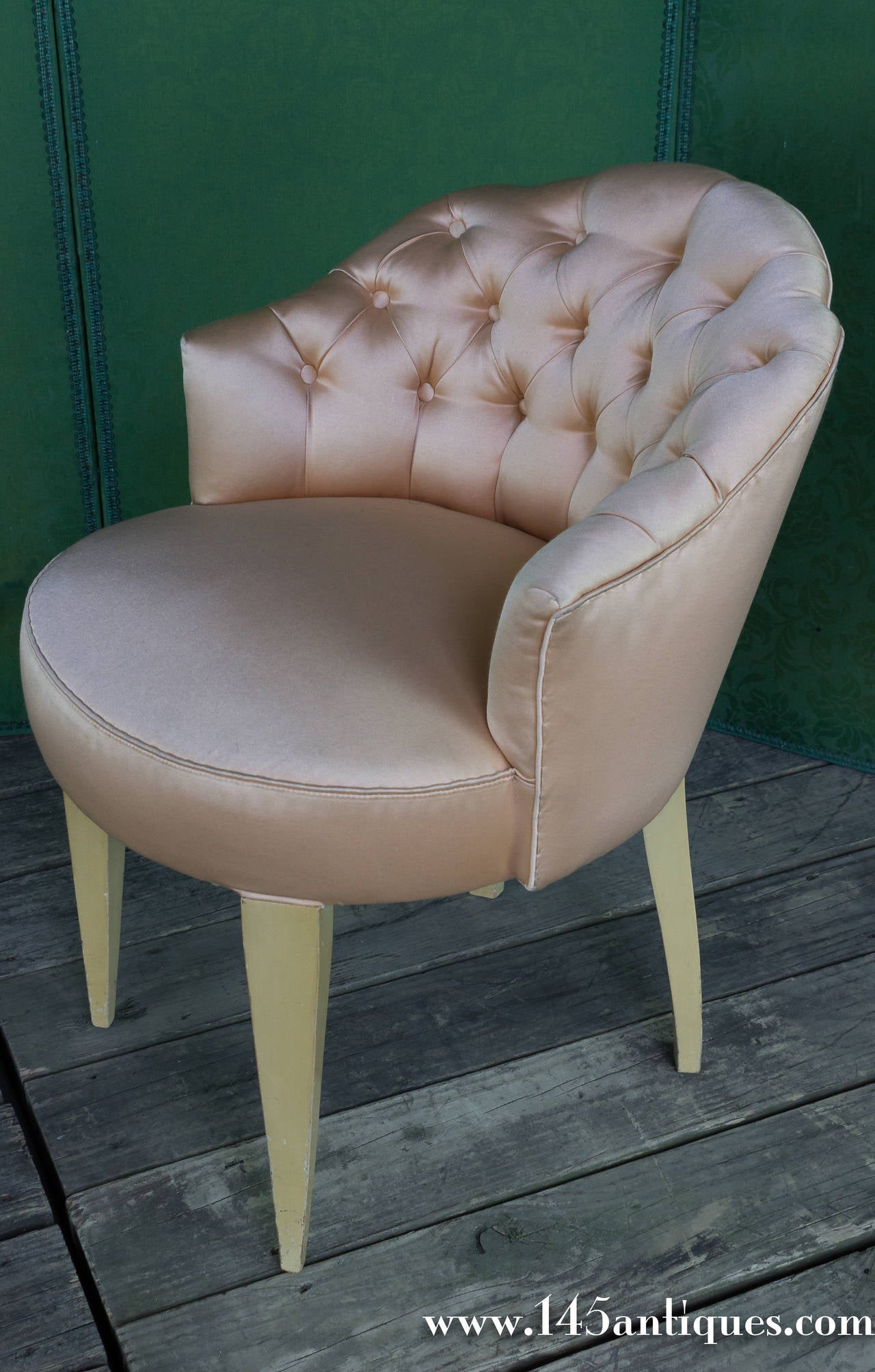 French tufted back vanity stool upholstered in a light peach satin. We have a matching slipper chair available.