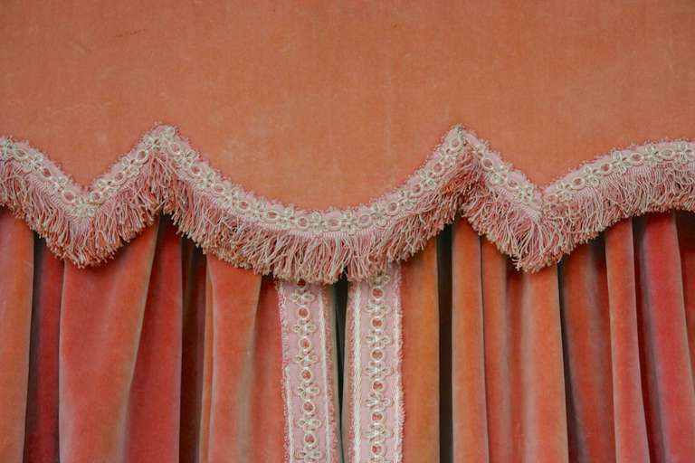 Beautiful pair of French lined pink velvet drapes with matching valance. The pieces are trimmed in fringe and embroidery.

These curtains / draperies are not for sale, they are for rental only.
