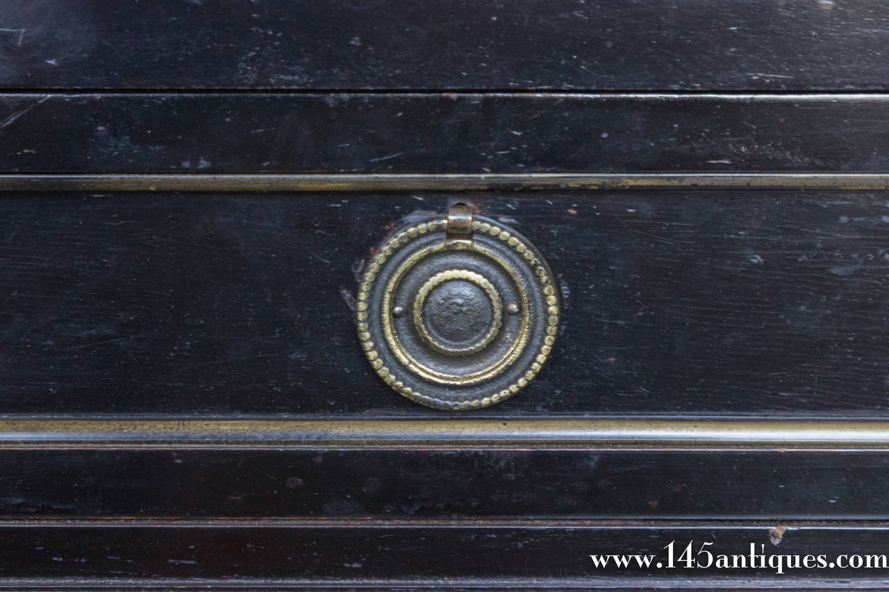 1940s French sideboard with an ebonized finish. The marble is in off-white with grey/greenish veining. The sideboard has four small drawers as well as three lower storage compartments. The piece currently does not have shelves but the price includes