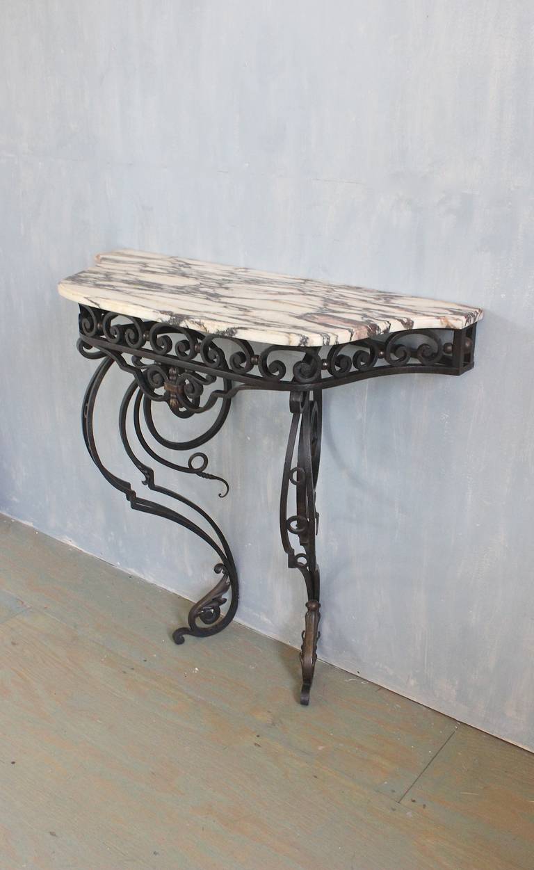 French 19th century wrought iron console with bronze detailing and white marble.