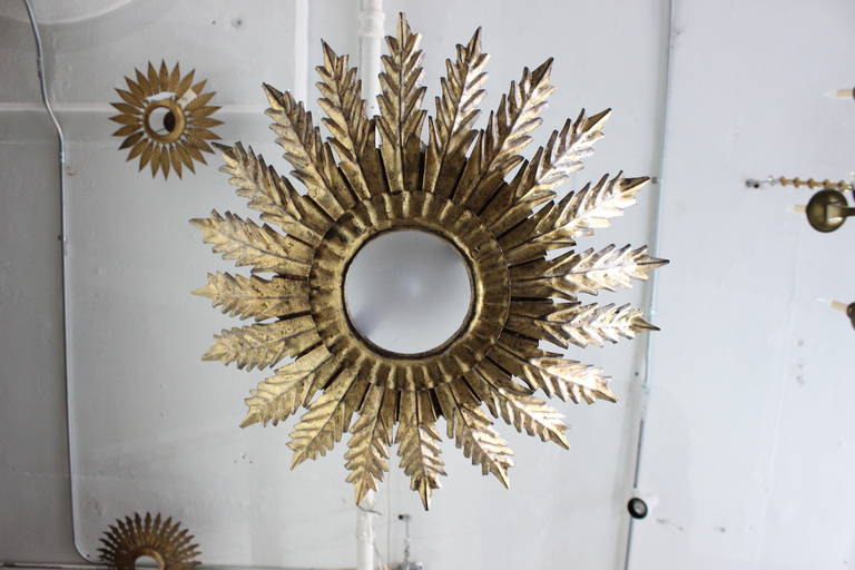 An unusual Spanish gilt metal ceiling fixture with decorative leaf pattern. Enhance the beauty of any room in your home with this elegant Spanish gilt metal ceiling fixture. The decorative leaf pattern adds a touch of whimsy and sophistication to