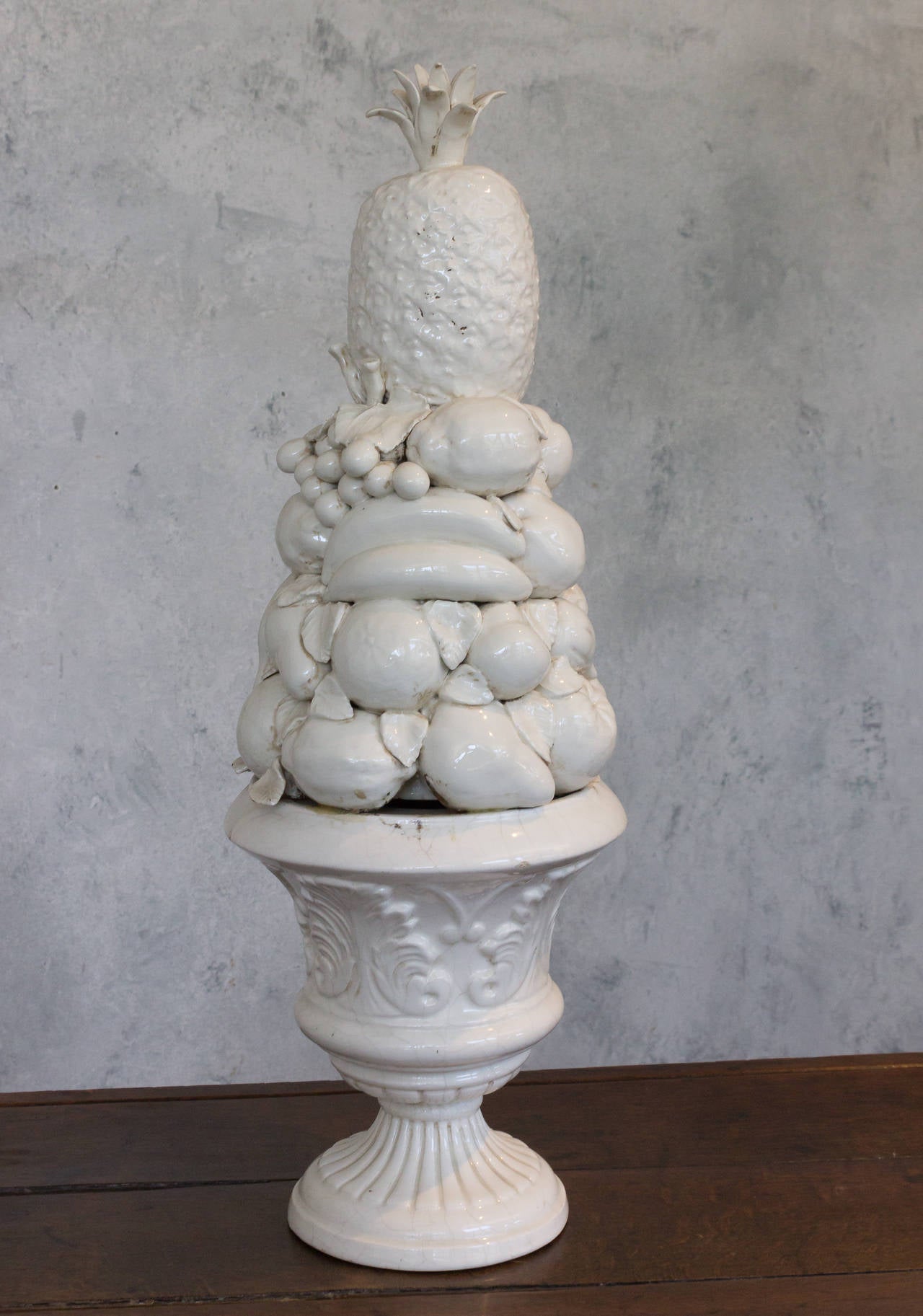 White ceramic centerpiece with various fruit and a pineapple top. Spanish, early 20th century. Good vintage condition.

Ref #: D0106-15

Dimensions: 32