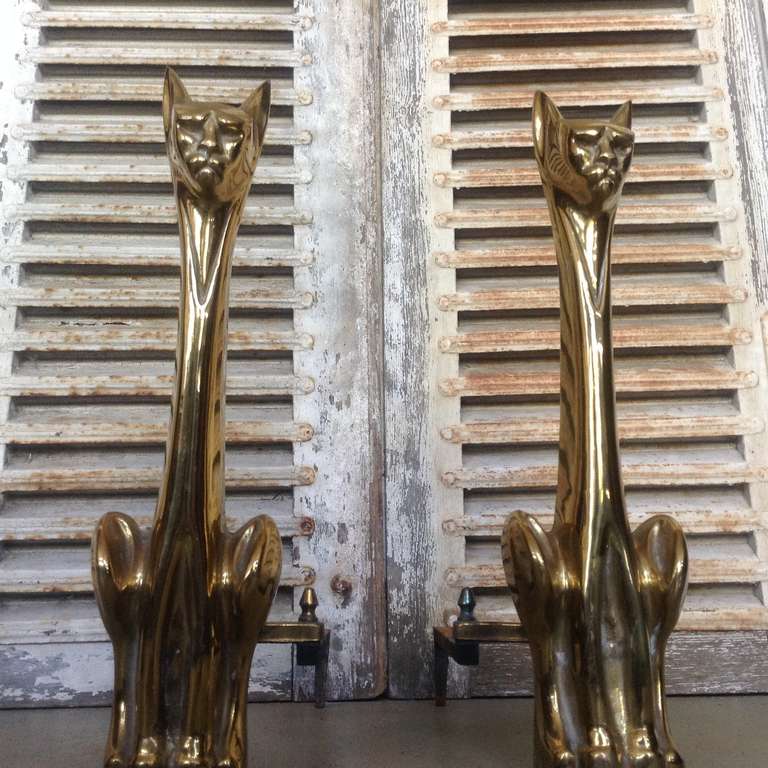 Pair of Cat shaped, polished brass andirons with cast iron supports.