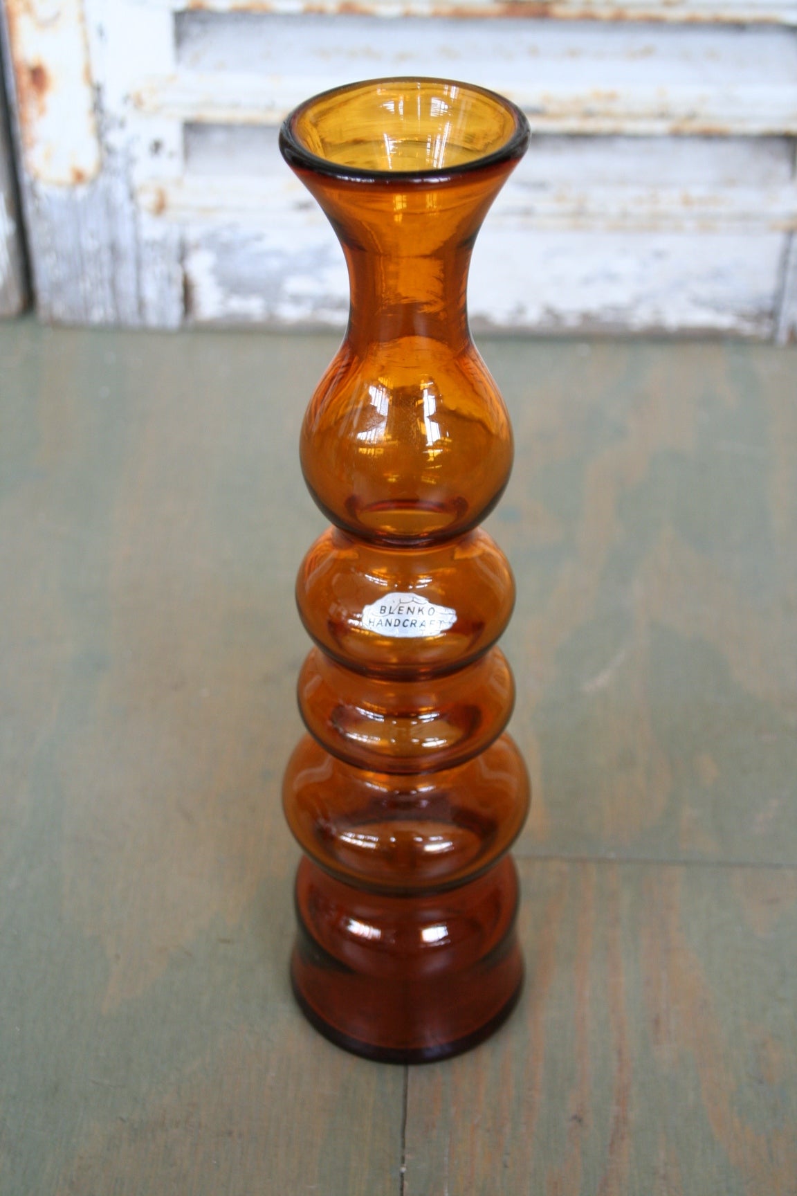 Handcrafted orange glass vase.