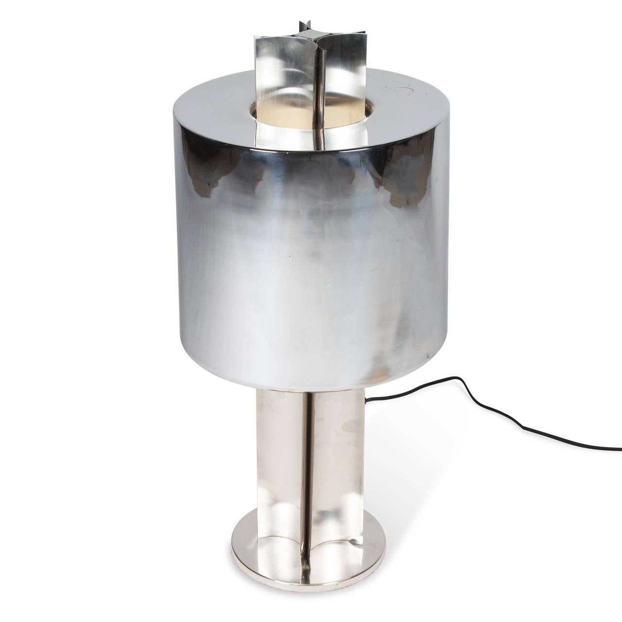 Polished steel table lamp, cylindrical shade mounted to pedestal base formed by an inverted quatrefoil, four bent flanges, French, 1970s. Measures: 8.5” D base, 12.5” D shade at widest, 27” H.

