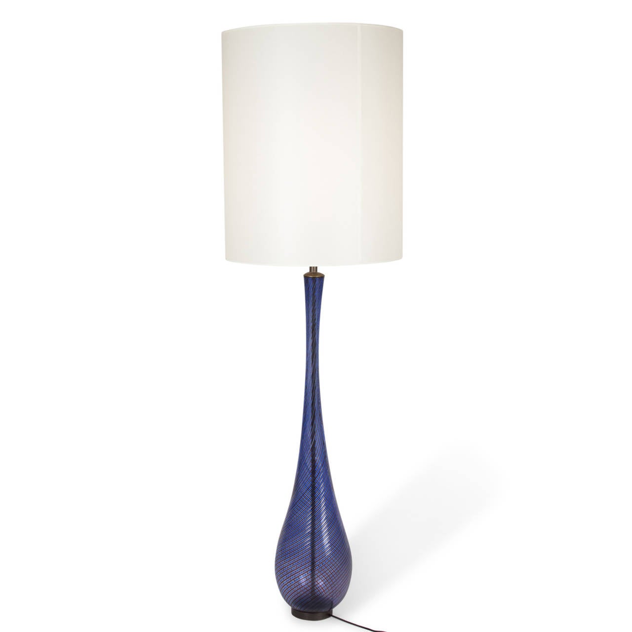 Dark blue swirl filigrana glass table lamp, the glass on circular bronze base, by Venini, Murano, Italy 1940s. In custom silk shade. Measures: 7 in. D, 54 in. H, 16 1/8 in. D shade at widest. 
 