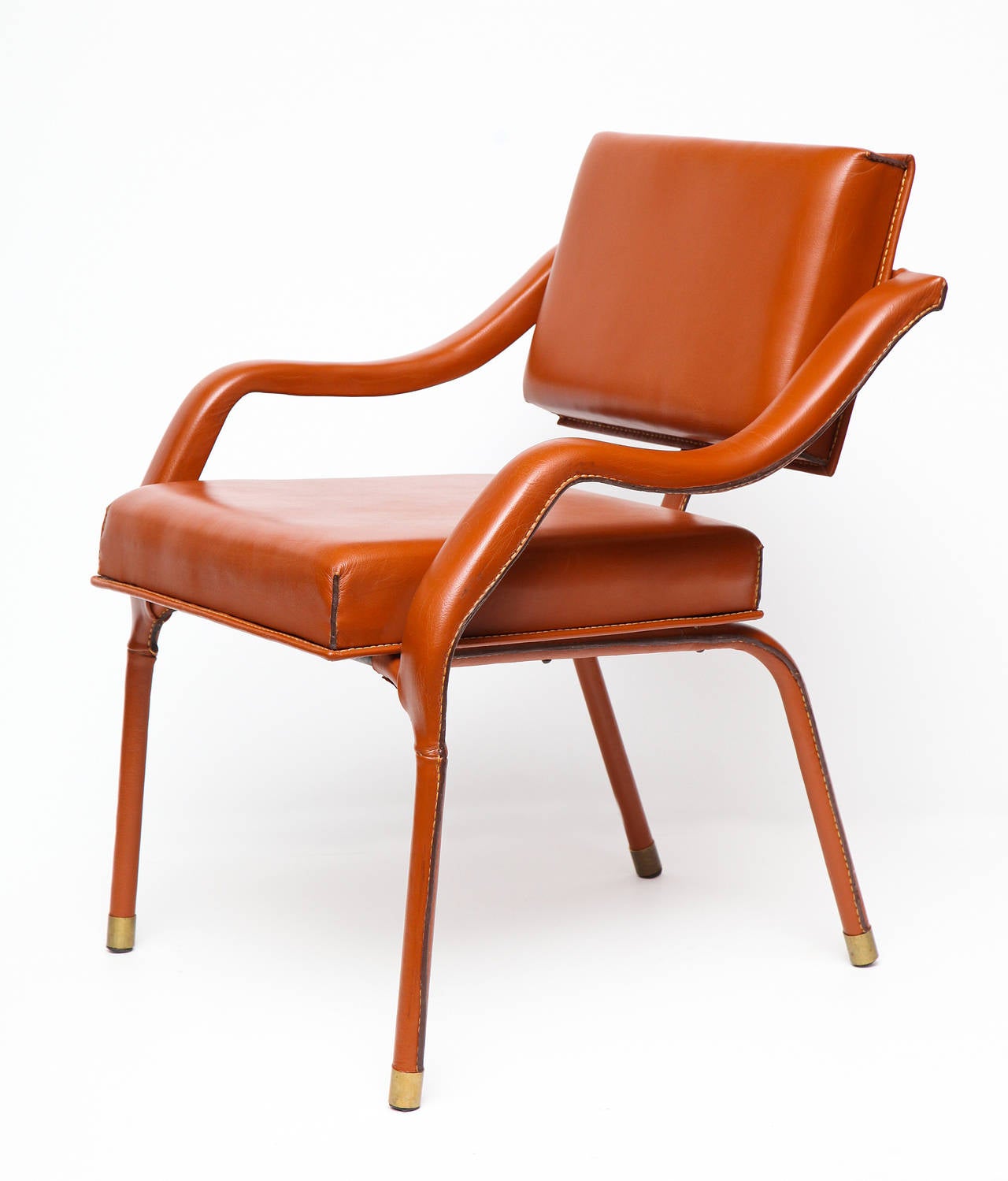 1960s leather armchair with metal sabots by Jacques Quinet.

An armchair with similar features is illustrated in Maldonando, Guitemie. Jacques Quinet. Paris: Les éditions de l'Amateur, 2000. 136.