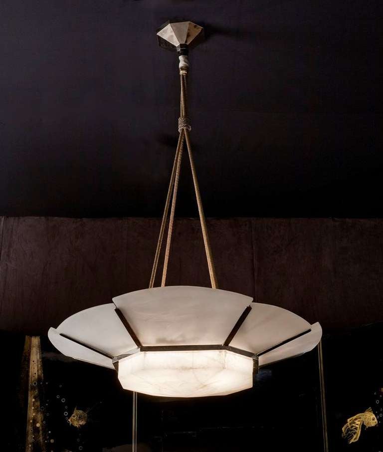 Fine and rare early Art Deco chandelier by Jules Leleu, in its original alabaster, silk ropes, and nickeled bronze

For illustrations of this model, see:
Jutheau, Viviane. Jules et André Leleu. Paris: Editions Vecteurs, 1989. 43, 171.
Mobilier