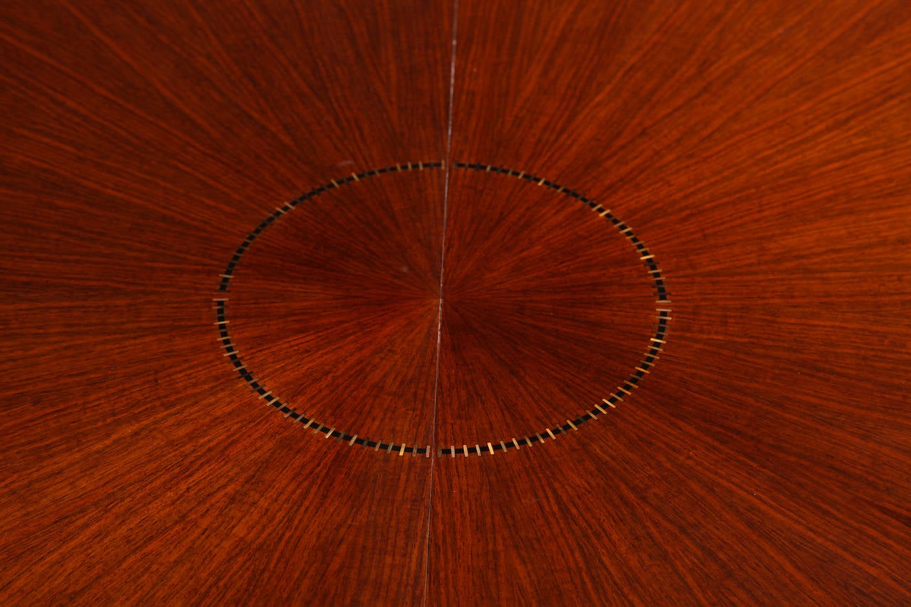 Mahogany dining table with ebony and mother-of-pearl inlay and bronze sabots by Jules Leleu.

Extendable, one original leaf available.

For a sketch of a similar model, see Siriex, Françoise. The House of Leleu. New York: Hudson Hills Press,