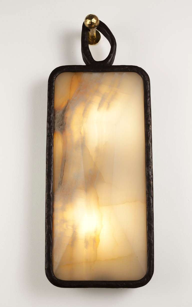 Cast bronze and onyx sconce with a patinated cast bronze hook by Rome based architect Achille Salvagni, recognized worldwide for bringing together Italian craftsmanship and his passion for luxurious materials and traditional techniques. 

Edition of