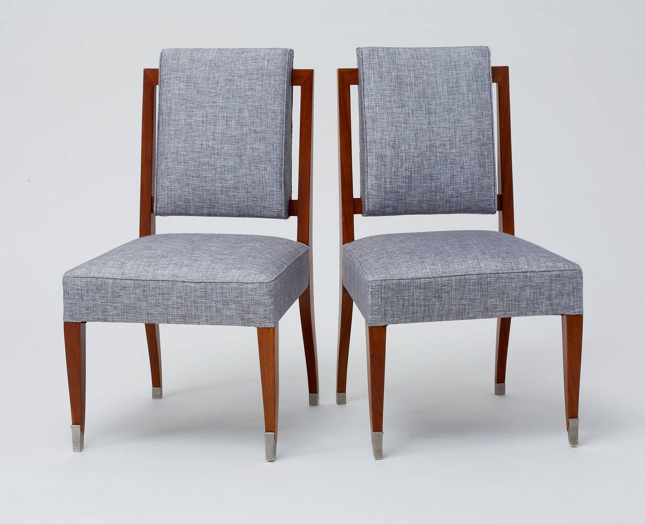 Pair of mahogany side chairs with nickel-plated bronze sabots by Maison Leleu.