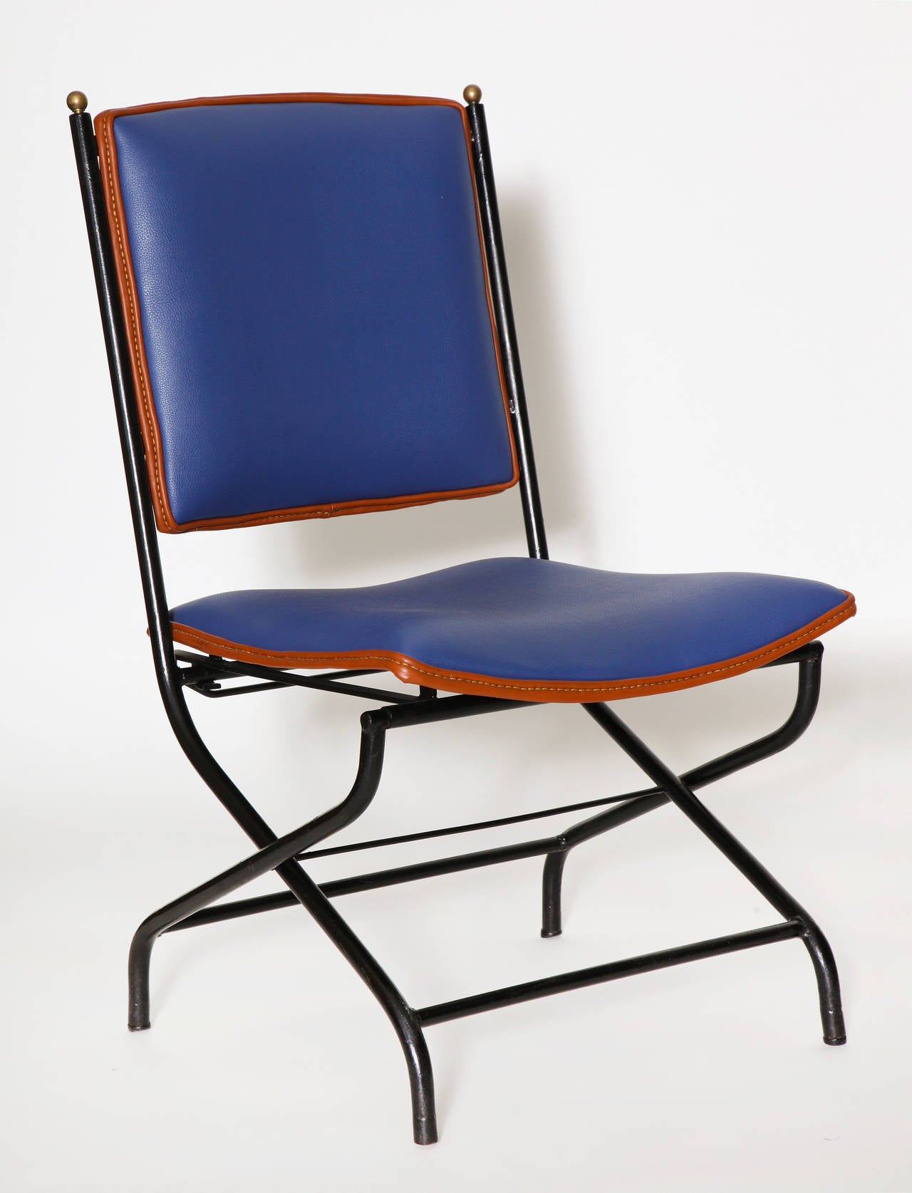 Pair of adjustable height lounge chairs in leather, bronze and brass, by Jacques Adnet.