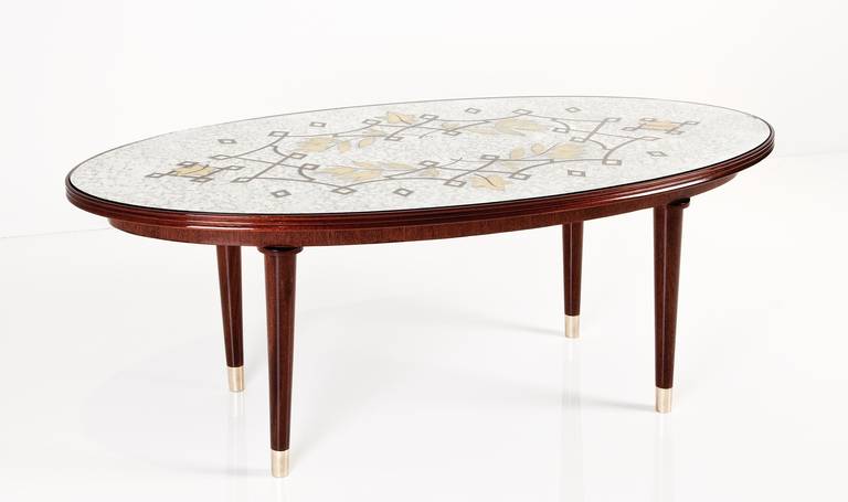 Mahogany coffee table with original églomisé top by Jules Leleu.

Provenance: Personal collection of Jean Leleu, acquired directly from the family of Jean Leleu.