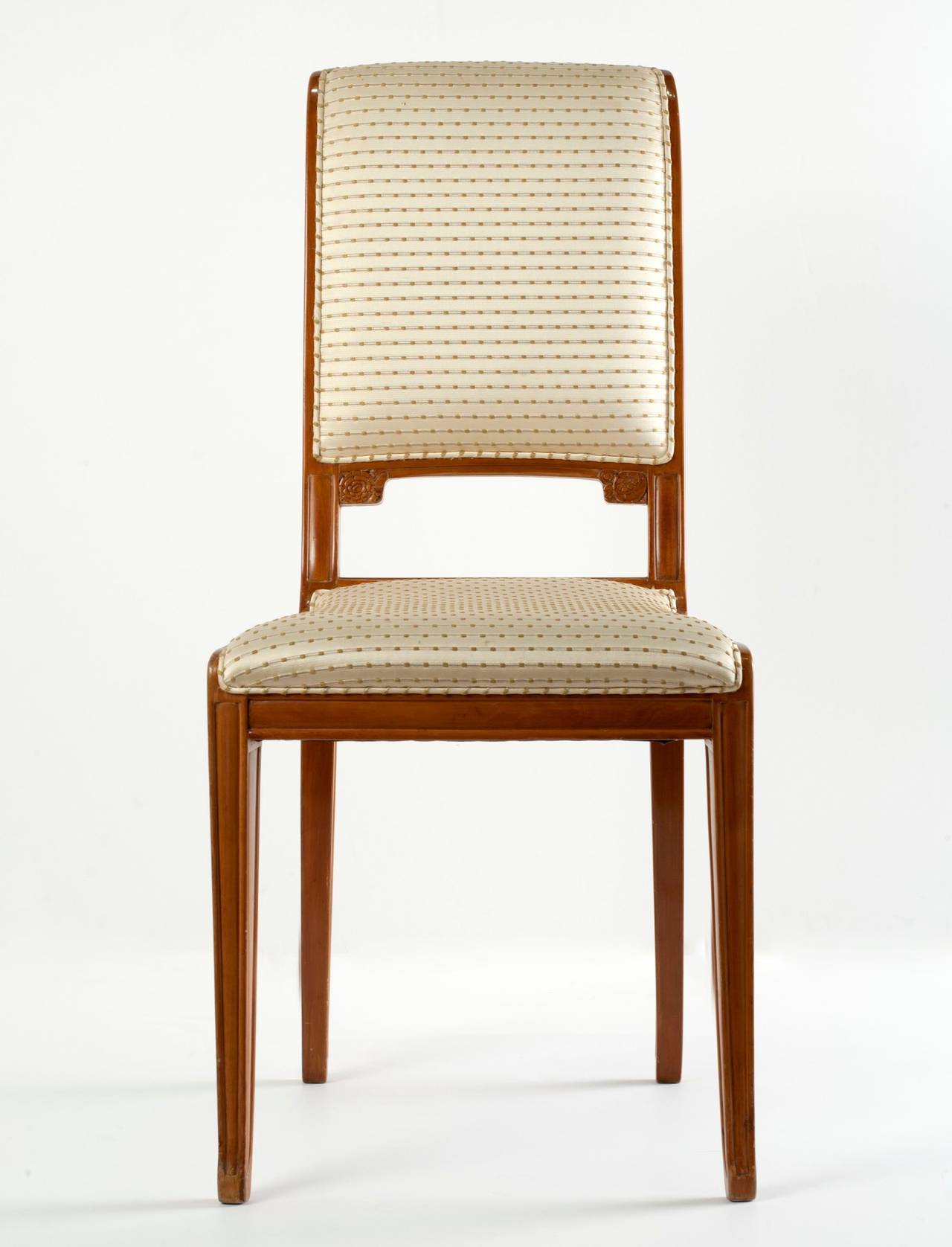 Carved fruitwood Art Deco side chair by Léon Jallot.

Provenance: This set of furniture, comprised of a pair of armchairs, a pair of side chairs, and a matching coffee table, was purchased directly by Madame Yvonne Zunz from Léon Jallot in