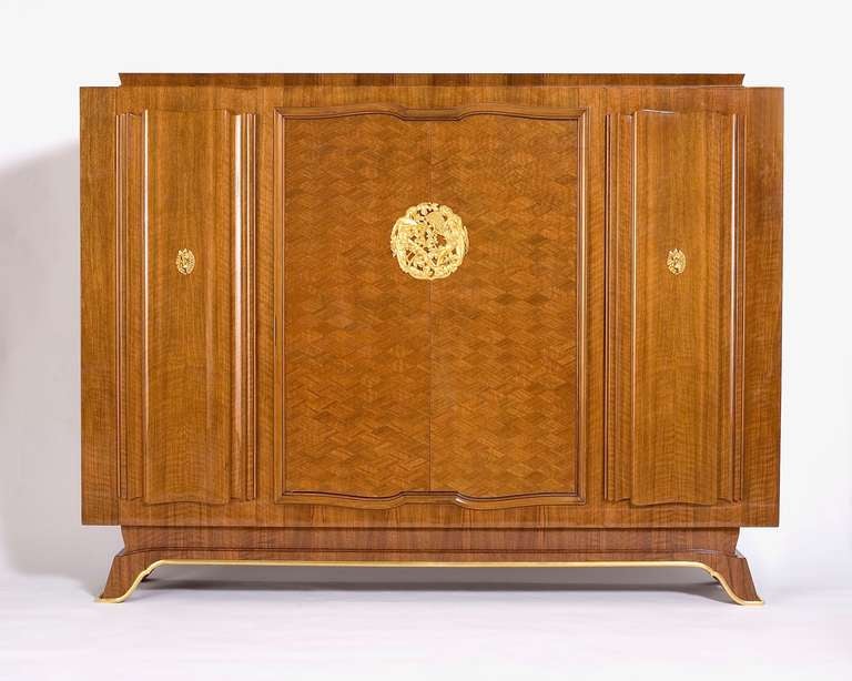 Fine walnut four-door cabinet by Jules Leleu with bronze medallion by Champreix

For an illustration of an identical cabinet, see Mobilier et Décoration, no. 5. December 1946.

For a sketch of an identical cabinet, see Siriex, Françoise. The