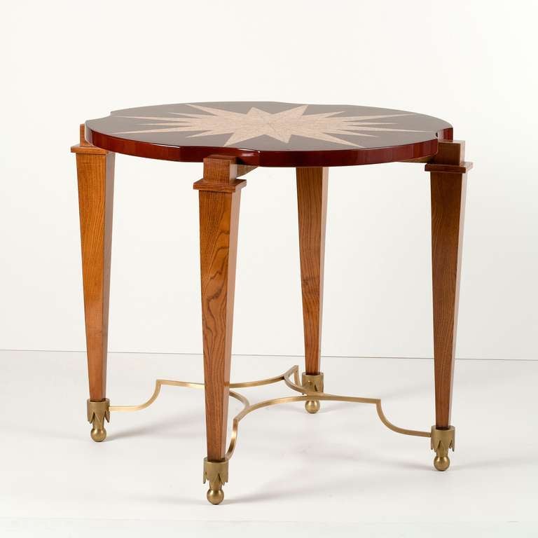 A French 1940's coffee table in polished oak, bronze, and an eggshell and red lacquered top