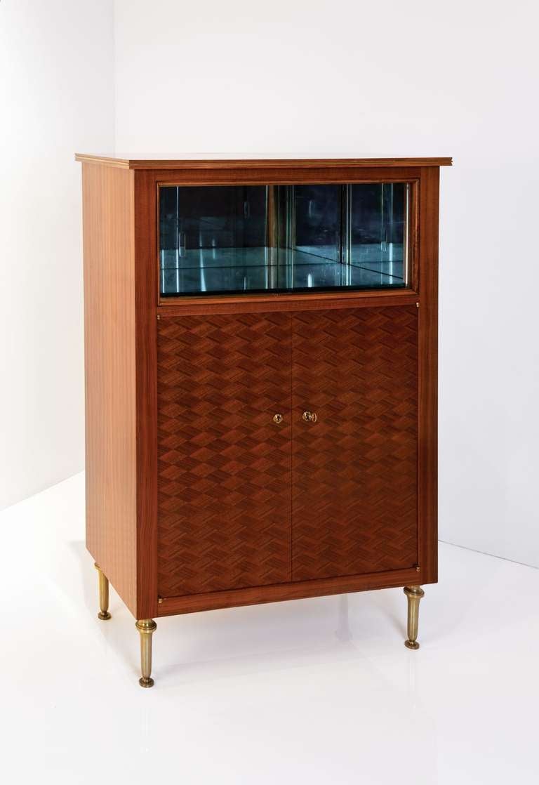 Vitrine by Jules Leleu in mahogany marquetry with glass sliding doors and gilt bronze legs

Bears its original label dated Nov 9th 1956, and is numbered on the back: 28332

Provenance: ?Commissioned by Mr. Renondin fils

Bibliography: A