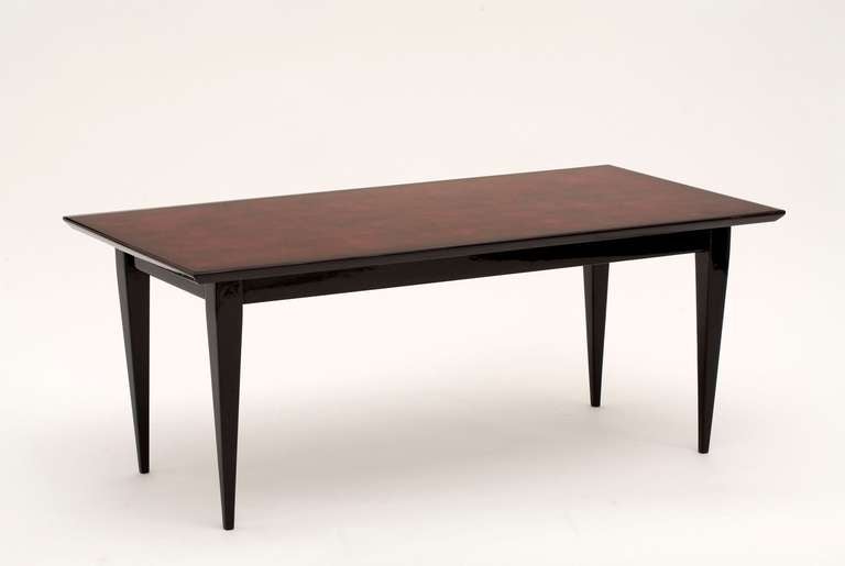 Coffee table by Bernard Dunand with its original lacquered top. The tabletop is a red/brown lacquer and the legs are in black lacquer. 

Stamped on the underside: 
Bernard Dunand 
26 RUE BEZOUT PARIS XIVe.