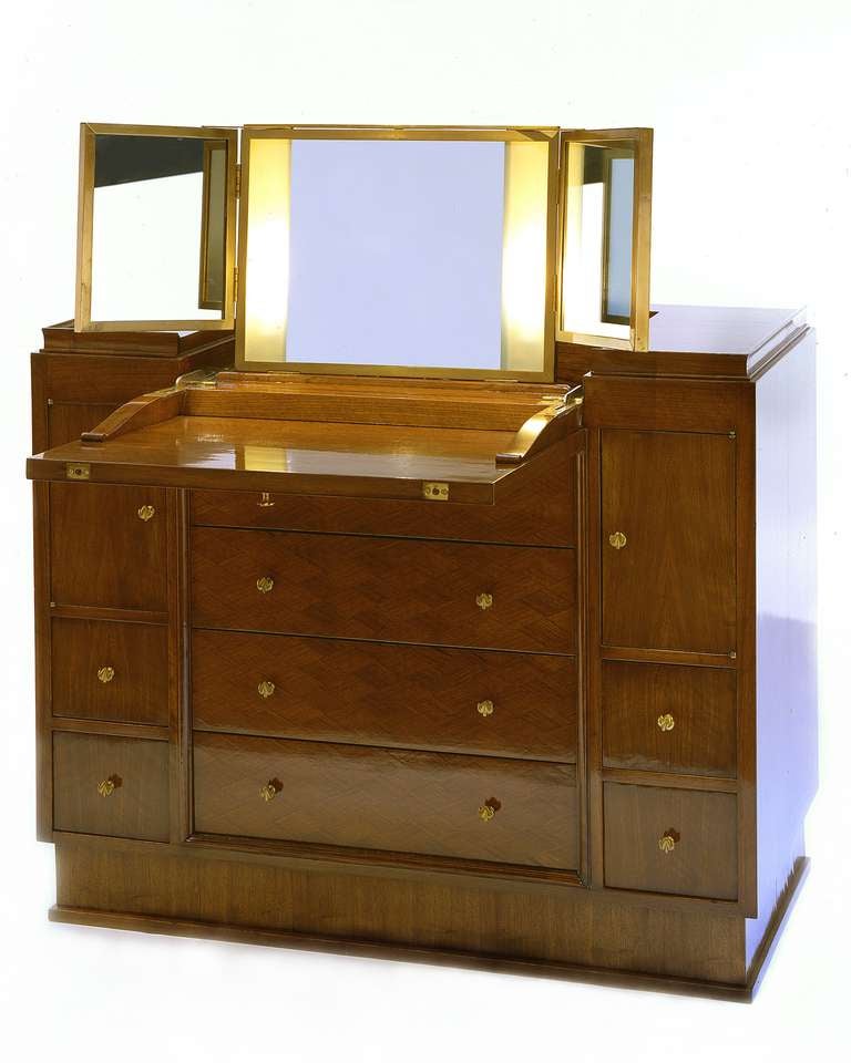 Rare palissander drop front vanity cabinet by Jules Leleu (1883-1961). The drop front opens to reveal an illuminated mirror in three sections

Bibliography: An identical cabinet designed for the Ile de France (1948) oceanliner is illustrated in