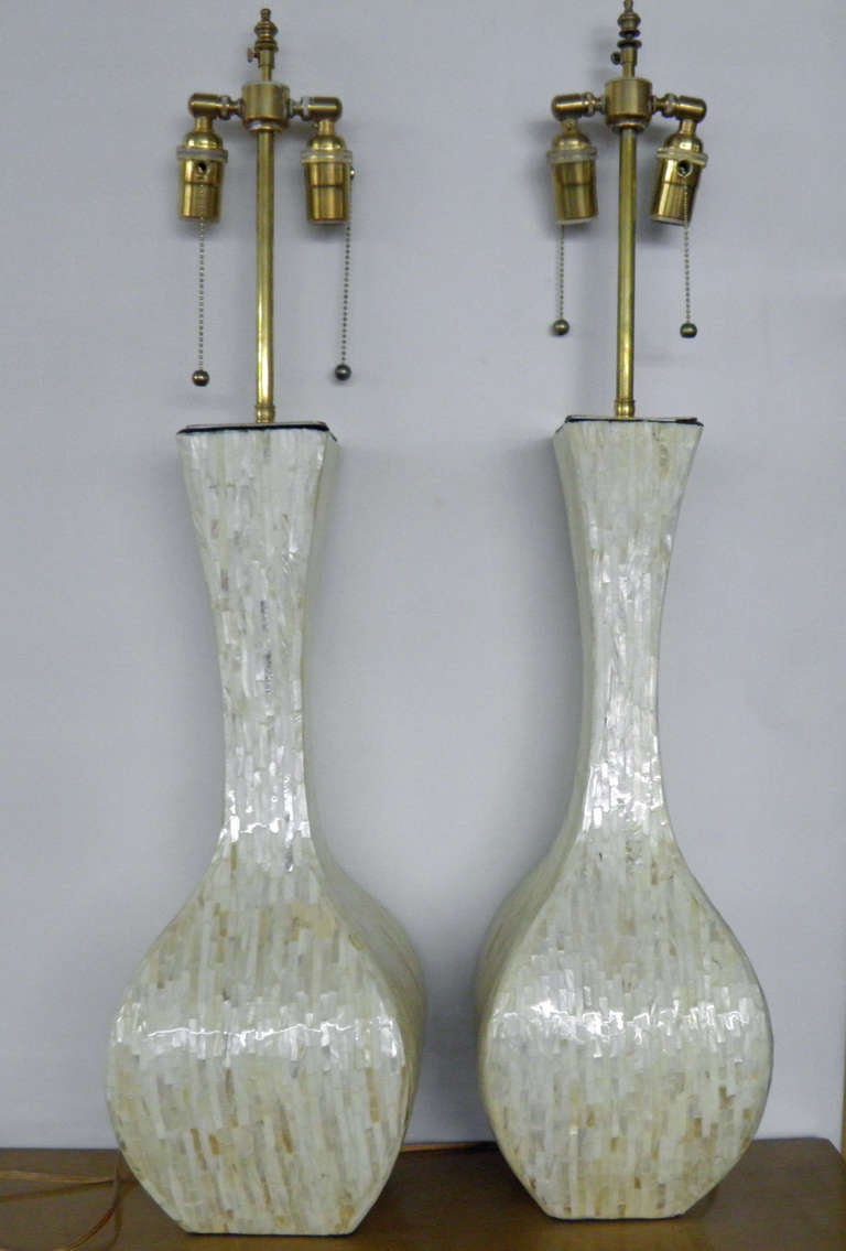 Pair of iridescent textured vases with lamp application   The hardware is in polished.  The dual sockets are individually controlled.  The finial post extends an additional 3