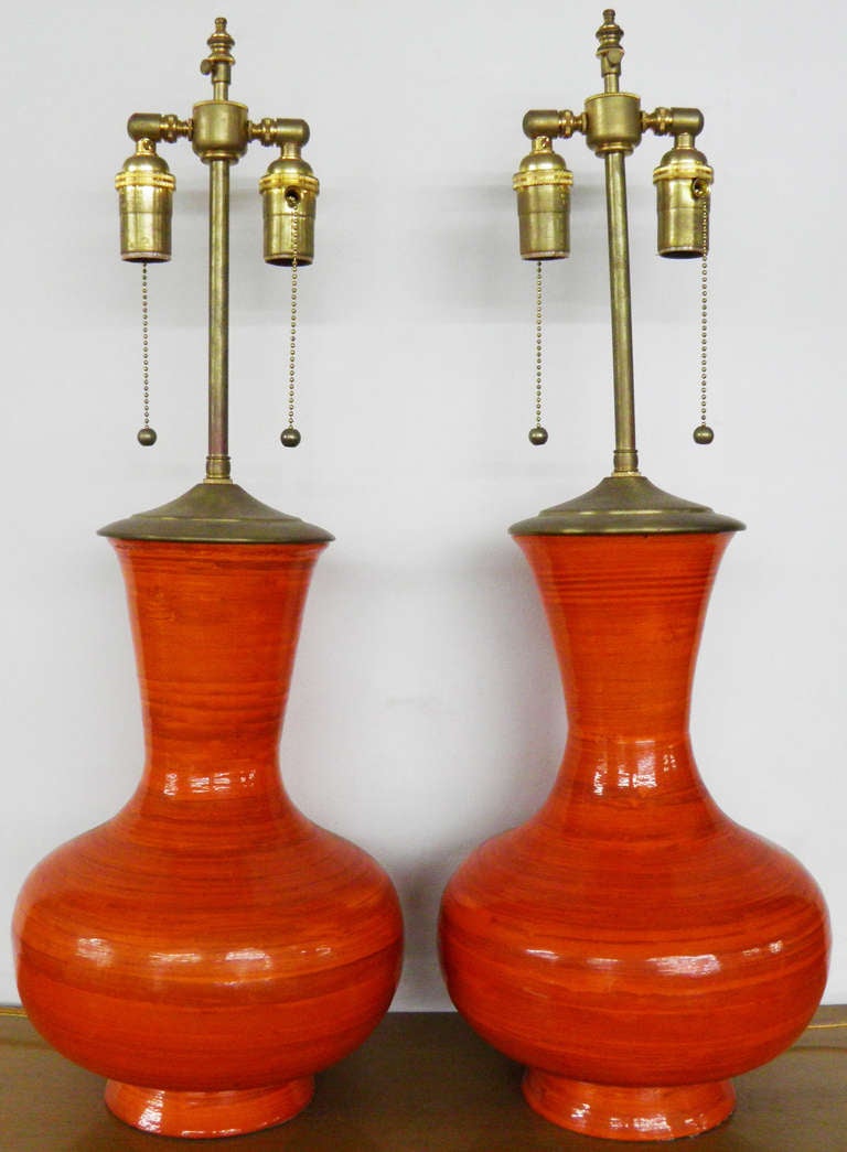Stunning and vibrant Orange ceramic vases with lamp application.  The hardware is Brass,  The dual sockets have individual controls,  The final post extends an additional 3