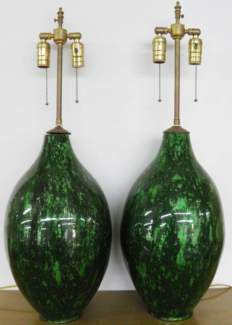 Pair of Marbled Green glazed vases with lamp application.  The hardware is Brass.  The twin sockets are individually controlled.  The finial post extends an additional 3