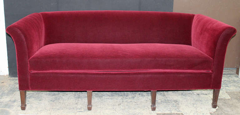 Elegant tuxedo style sofa in rich Merlot Mohair. Fully refurbished and reupholstered. The scored legs are in a walnut finish. The seating composition is foam core wrapped in down/down feather. The seat depth is 21